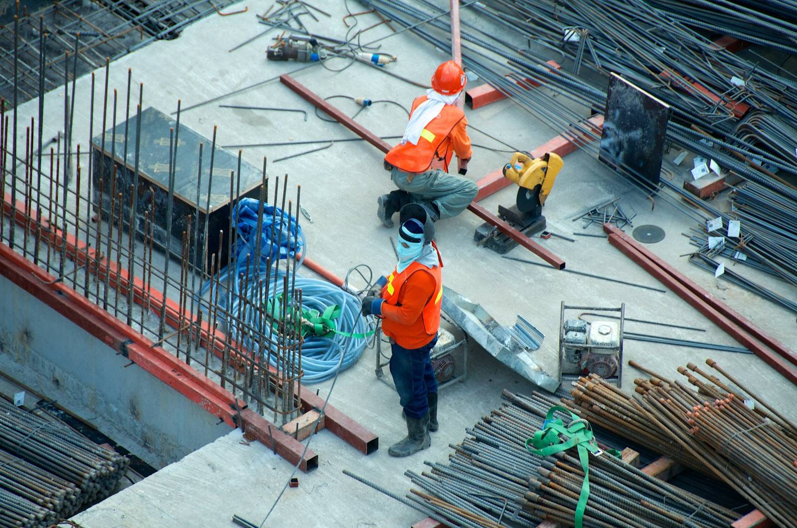 Construction workers placing reinforcing steel on site